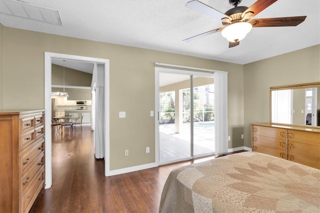 7472 Clearmeadow Dr, Spring Hill, FL 34606 - bedroom featuring access to exterior, baseboards, dark wood-type flooring, and a textured ceiling