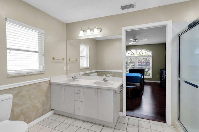 7472 Clearmeadow Dr, Spring Hill, FL 34606 - ensuite bathroom featuring a textured ceiling, visible vents, ensuite bathroom, and a sink