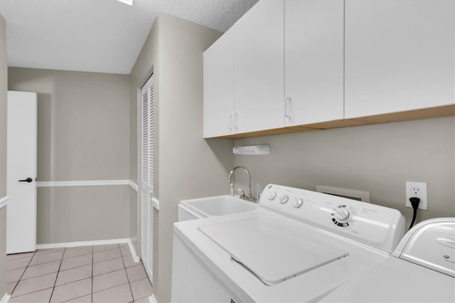 7472 Clearmeadow Dr, Spring Hill, FL 34606 - clothes washing area with baseboards, light tile patterned flooring, cabinet space, a sink, and washer and clothes dryer