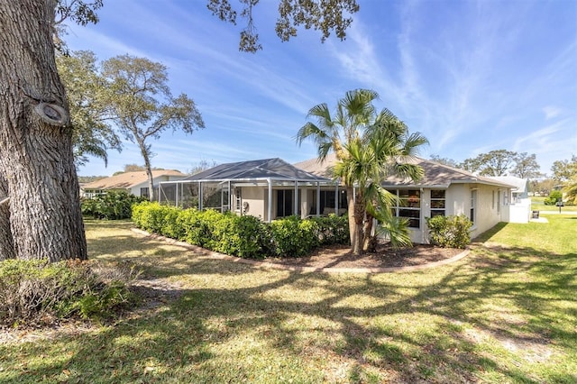 7472 Clearmeadow Dr, Spring Hill, FL 34606 - back of house featuring stucco siding, a yard, and a lanai