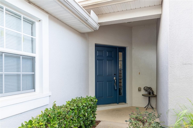 entrance to property with stucco siding