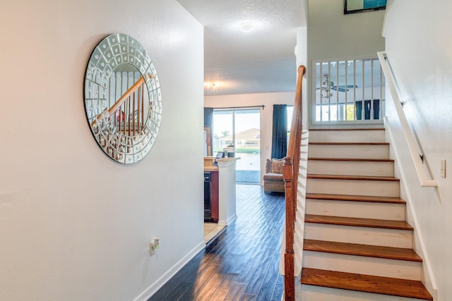 stairs featuring wood finished floors and baseboards