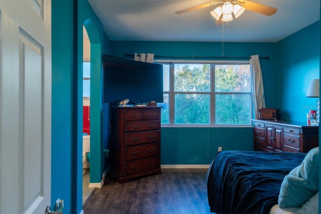 bedroom with baseboards, ceiling fan, and dark wood finished floors