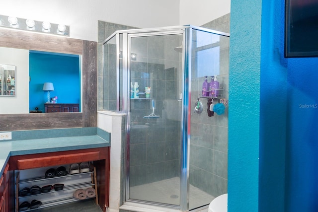 bathroom featuring toilet and a stall shower