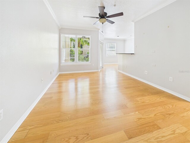 1810 E Palm Ave Unit 6104, Tampa, FL 33605 - unfurnished living room with crown molding, light wood-type flooring, ceiling fan, and baseboards