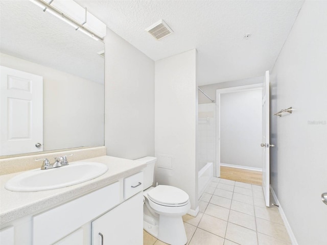 1810 E Palm Ave Unit 6104, Tampa, FL 33605 - full bathroom featuring toilet, vanity, tile patterned flooring, a textured ceiling, and shower / tub combination