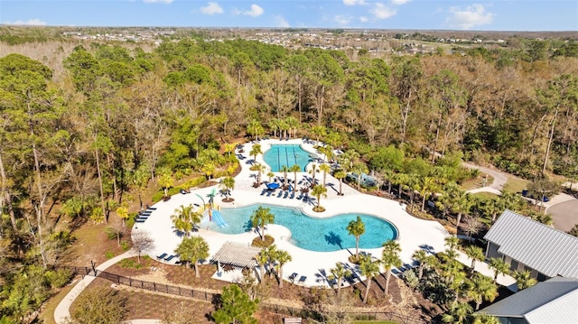bird's eye view with a wooded view
