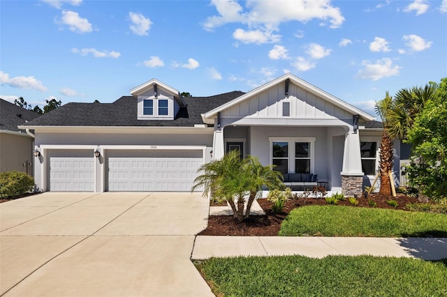 3966 Tour Trce, Land O Lakes, FL 34638 - view of front of home with a garage, board and batten siding, driveway, and a shingled roof