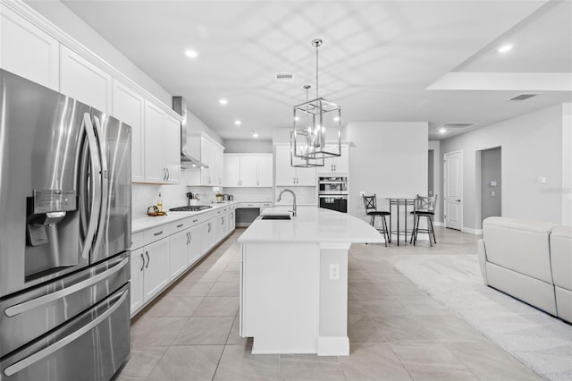 3966 Tour Trce, Land O Lakes, FL 34638 - kitchen featuring stainless steel appliances, a sink, wall chimney exhaust hood, light countertops, and recessed lighting