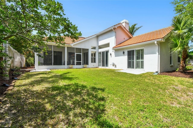 441 Village Dr, Tarpon Springs, FL 34689 - rear view of house featuring stucco siding, a sunroom, a chimney, and a tiled roof