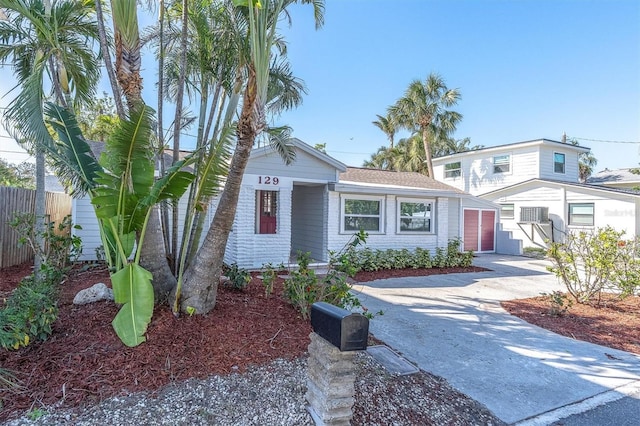 129 94th Ave, Treasure Island, FL 33706 - traditional-style house featuring driveway, a garage, and fence
