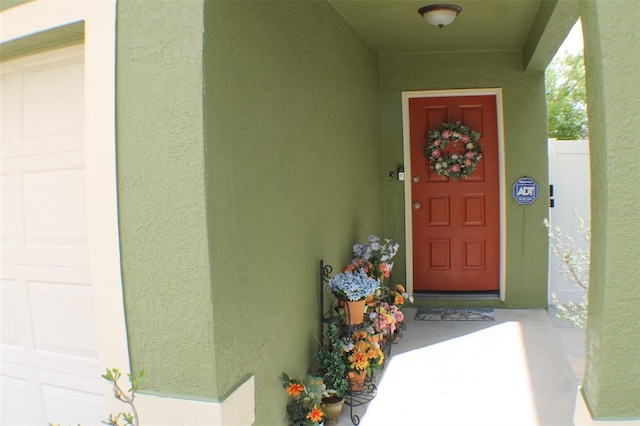 property entrance featuring stucco siding