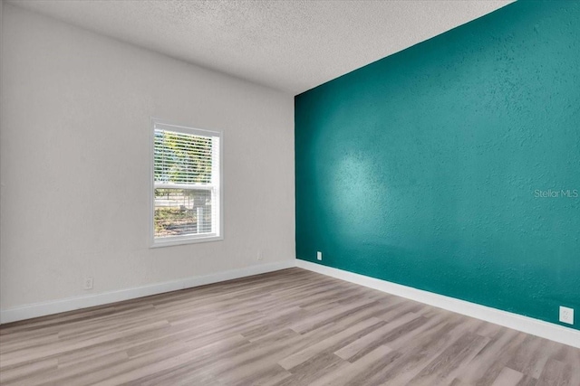 3101 N 15th St, Tampa, FL 33605 - empty room with baseboards, a textured ceiling, wood finished floors, and a textured wall