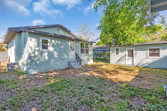 3101 N 15th St, Tampa, FL 33605 - rear view of house with stucco siding, entry steps, central AC, and fence