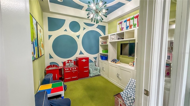 game room with carpet flooring and a notable chandelier