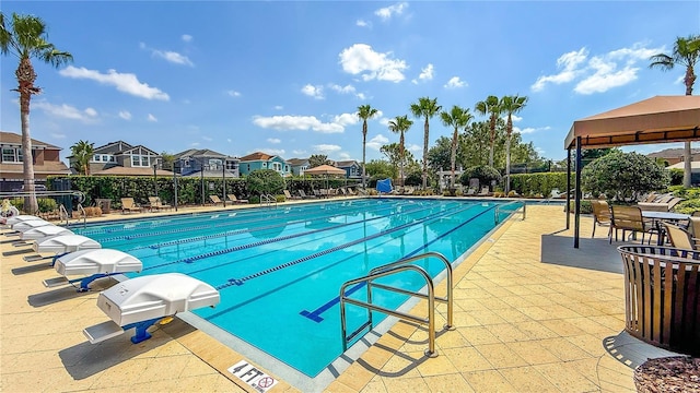 pool with fence, a gazebo, a residential view, and a patio
