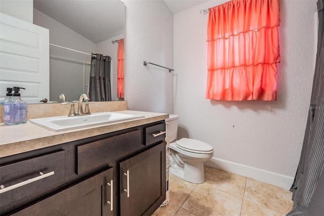 bathroom with vanity, baseboards, tile patterned flooring, curtained shower, and toilet