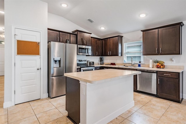 kitchen featuring visible vents, a sink, stainless steel appliances, dark brown cabinets, and vaulted ceiling