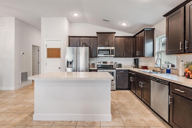 kitchen featuring visible vents, light tile patterned flooring, a sink, dark brown cabinets, and appliances with stainless steel finishes