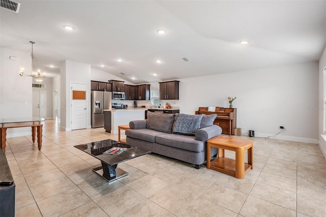 living room with light tile patterned floors, visible vents, an inviting chandelier, recessed lighting, and vaulted ceiling