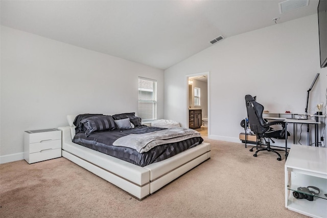 carpeted bedroom featuring visible vents, baseboards, connected bathroom, and vaulted ceiling
