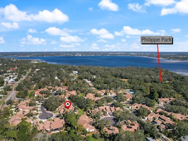 drone / aerial view featuring a residential view and a water view