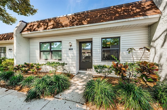 9214 Mission Oaks Blvd, Seminole, FL 33776 - property entrance with covered porch and roof with shingles