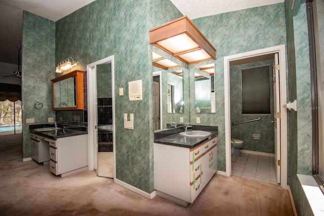 full bathroom with baseboards, toilet, wallpapered walls, and a sink