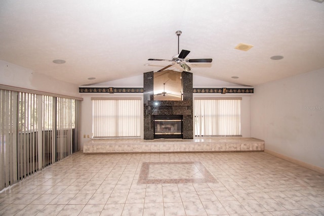 unfurnished living room featuring ceiling fan, vaulted ceiling, tile patterned floors, and a fireplace
