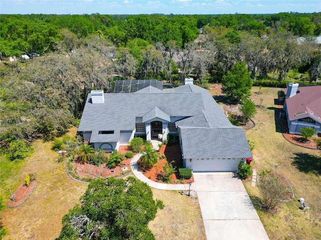 drone / aerial view with a wooded view