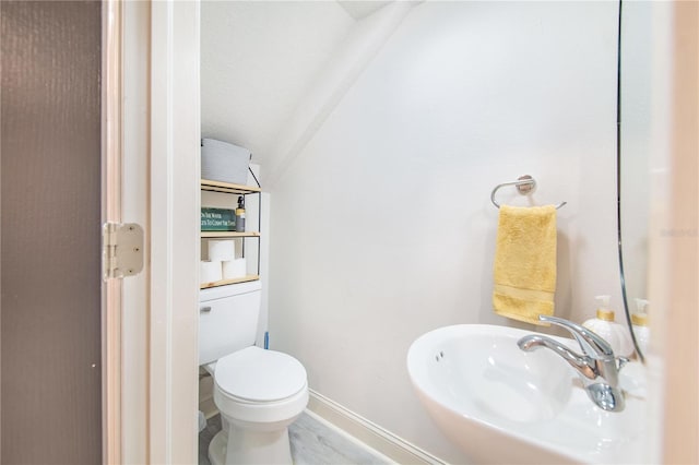 506 S Willow Ave Unit 7, Tampa, FL 33606 - bathroom with a sink, baseboards, lofted ceiling, and toilet