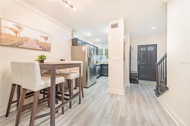 506 S Willow Ave Unit 7, Tampa, FL 33606 - dining space with light wood-type flooring, visible vents, crown molding, baseboards, and stairs