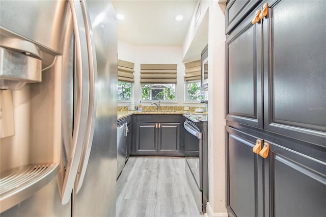 506 S Willow Ave Unit 7, Tampa, FL 33606 - kitchen with a sink, light stone counters, recessed lighting, stainless steel appliances, and light wood-style floors