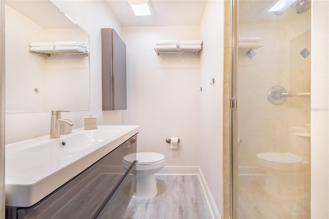 506 S Willow Ave Unit 7, Tampa, FL 33606 - bathroom featuring vanity, wood finished floors, baseboards, a shower stall, and toilet
