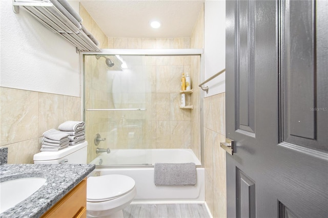 506 S Willow Ave Unit 7, Tampa, FL 33606 - bathroom with toilet, wood finished floors, combined bath / shower with glass door, tile walls, and vanity