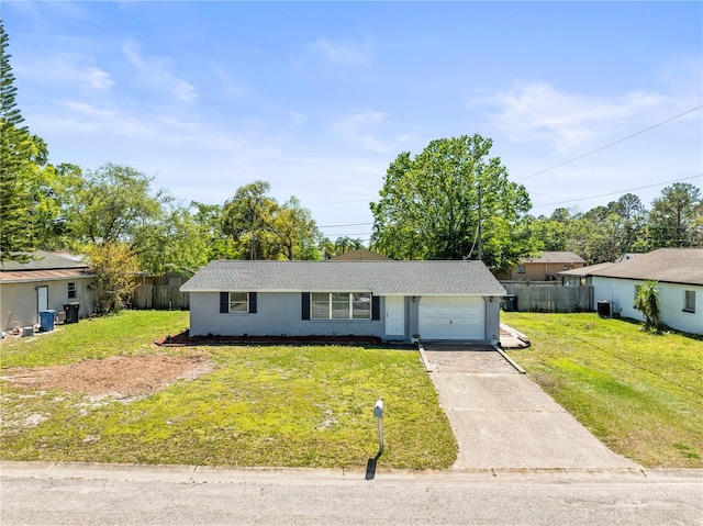 single story home featuring a front yard, an attached garage, fence, and driveway