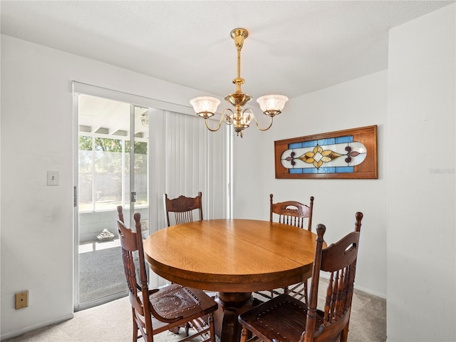 carpeted dining area featuring an inviting chandelier and baseboards
