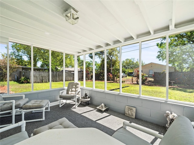 sunroom with beamed ceiling and an outdoor living space