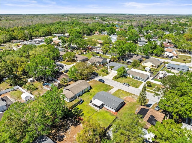 bird's eye view featuring a residential view and a wooded view