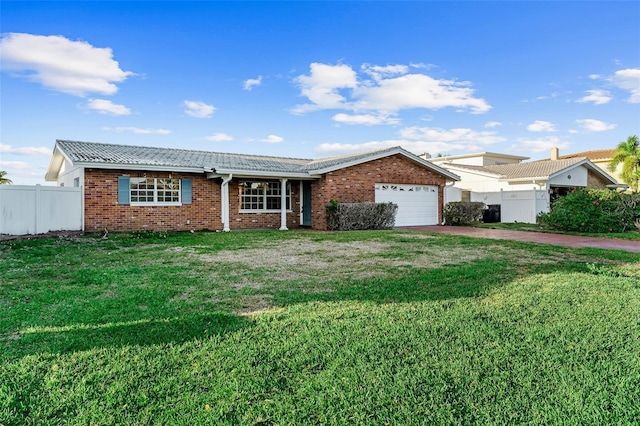 ranch-style house with fence, a front lawn, concrete driveway, a garage, and brick siding