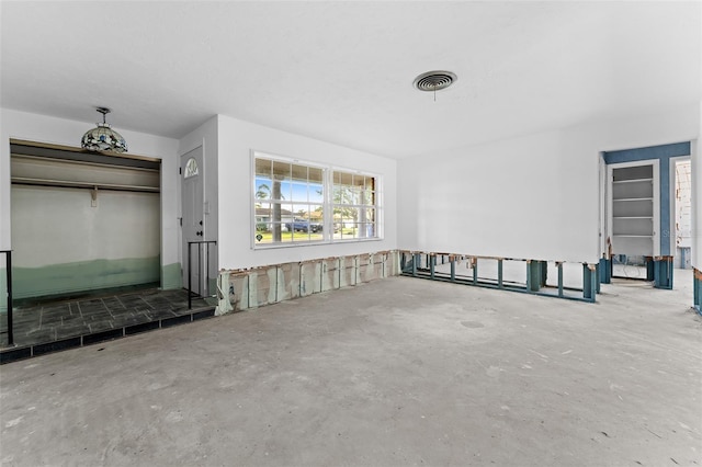 unfurnished living room featuring visible vents and unfinished concrete flooring