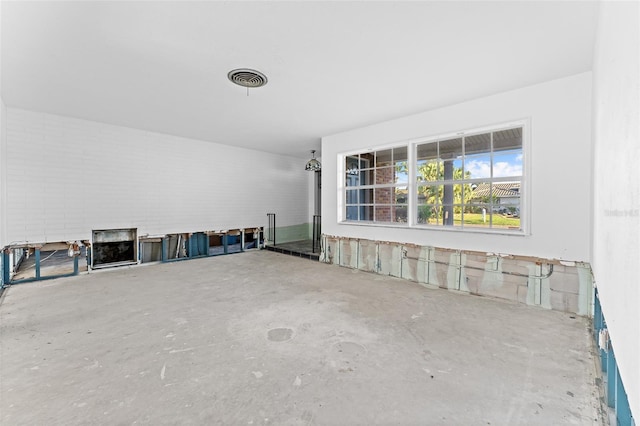 interior space with visible vents and unfinished concrete floors