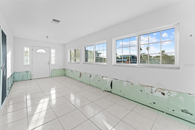 foyer with light tile patterned floors and visible vents