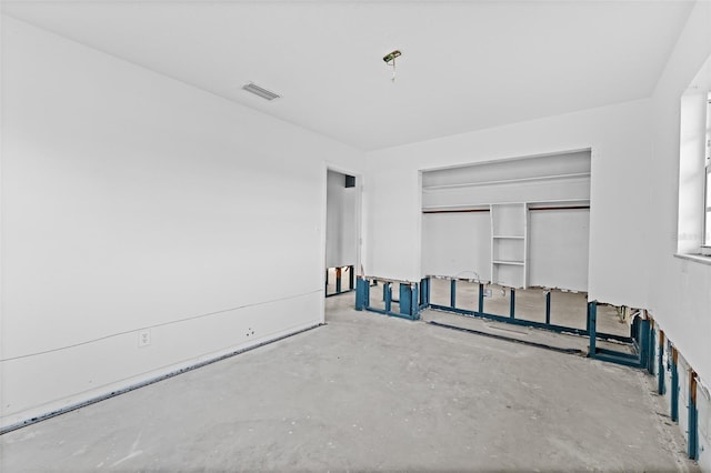 empty room featuring unfinished concrete flooring and visible vents