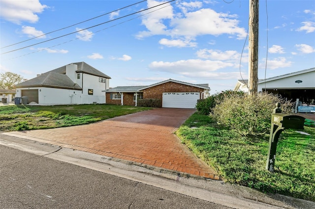 view of front of property with decorative driveway, an attached garage, and a front lawn