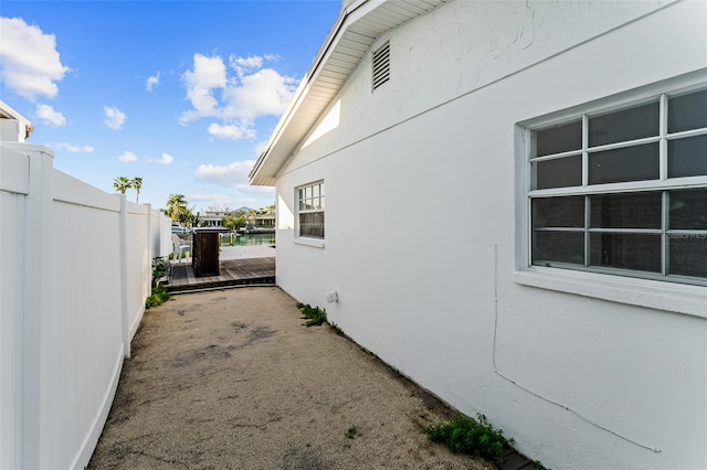 view of property exterior featuring fence and stucco siding