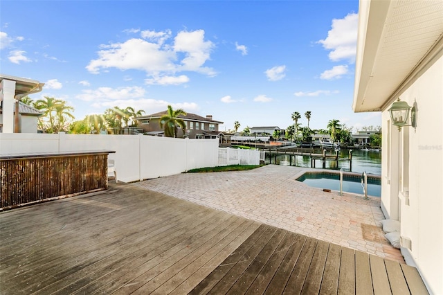 wooden deck with fence and a water view