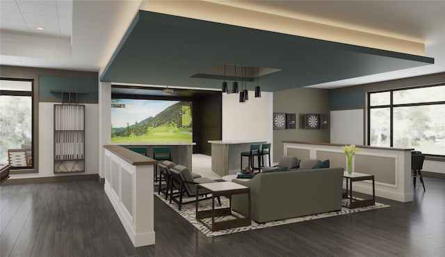 living room with recessed lighting, baseboards, dark wood-style floors, and a raised ceiling
