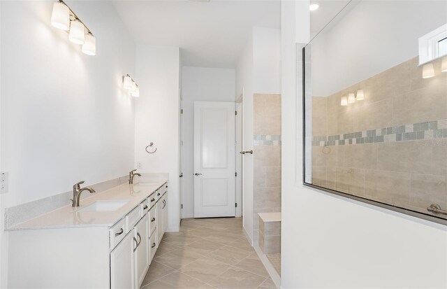bathroom featuring double vanity, walk in shower, and a sink