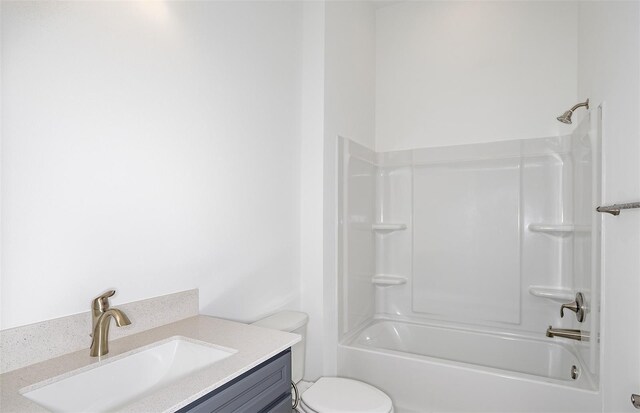 bathroom with toilet, tub / shower combination, and vanity
